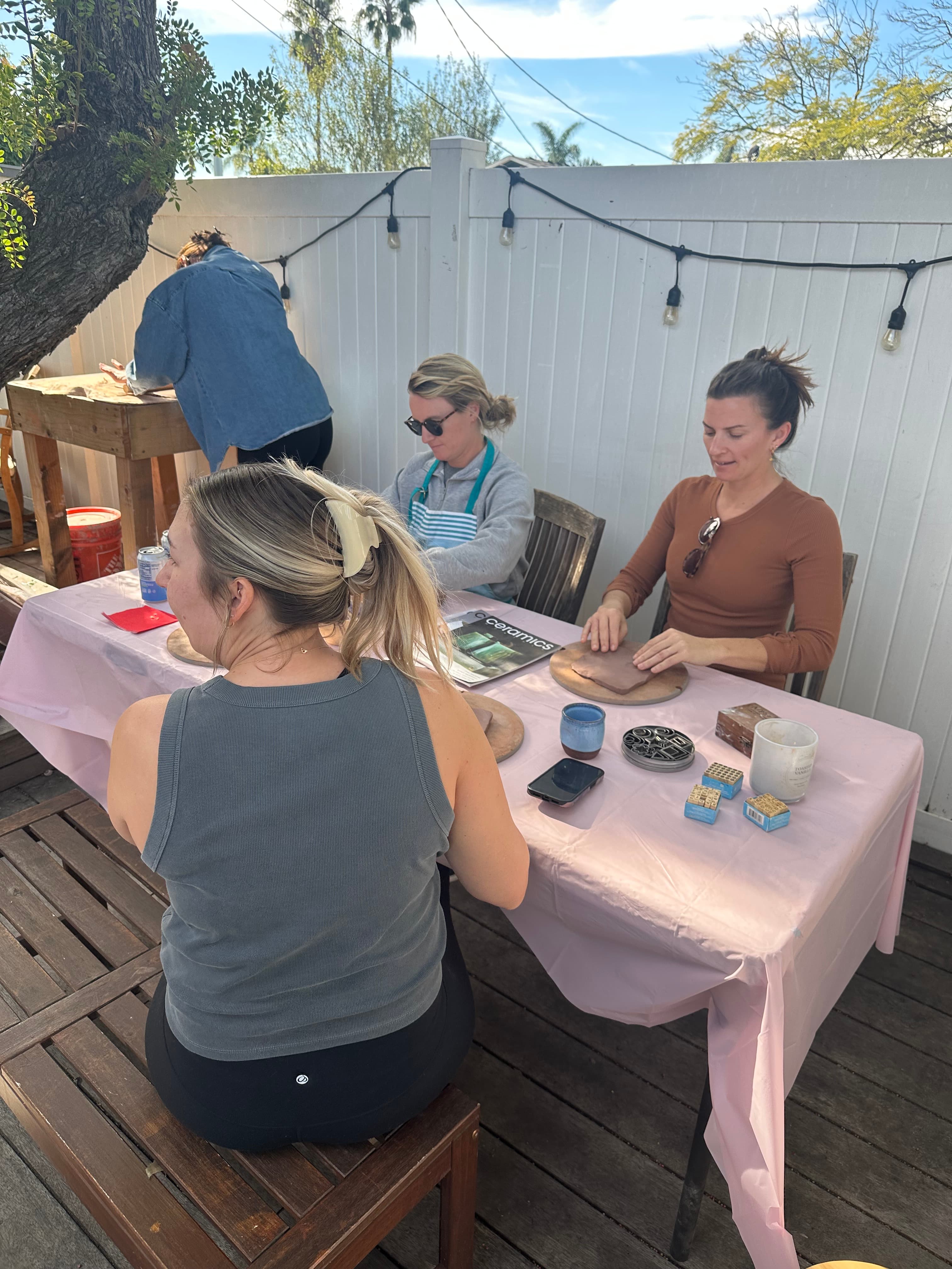Bachelorette party making pottery outdoors